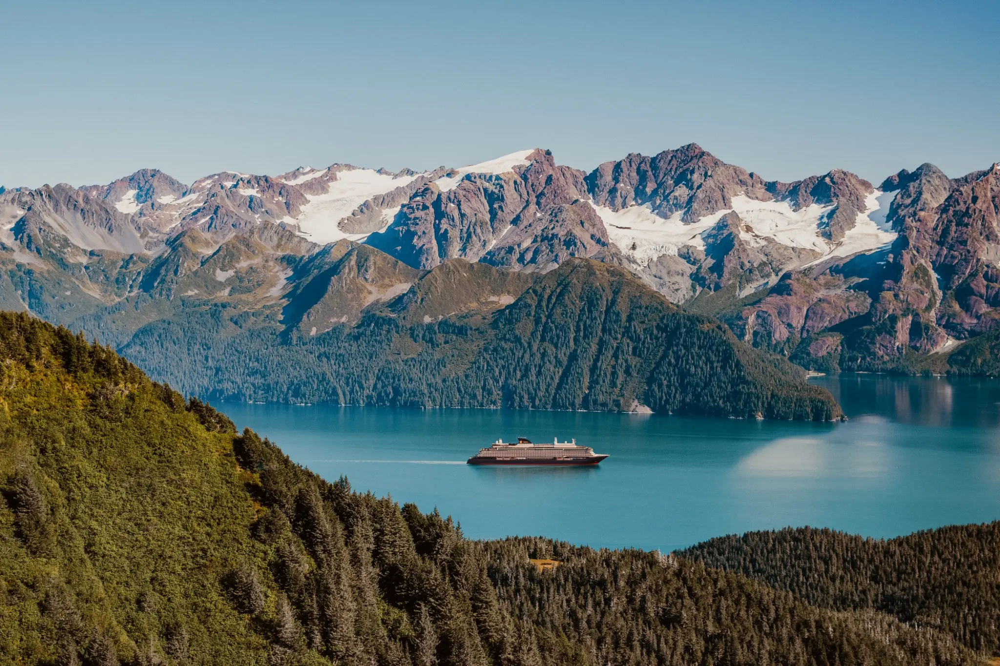 EXPLORA III sailing through an Alaska mountain landscape