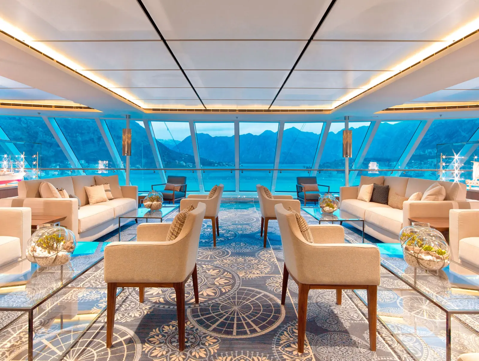 Panoramic windows and seating in the Explorers Lounge aboard a Viking ocean ship