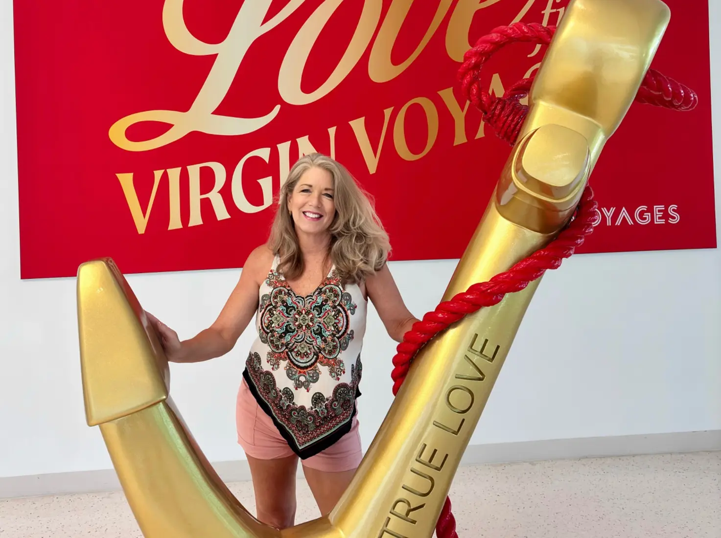 Melissa Lagerquist aboard Virgin Voyages with the gold anchor