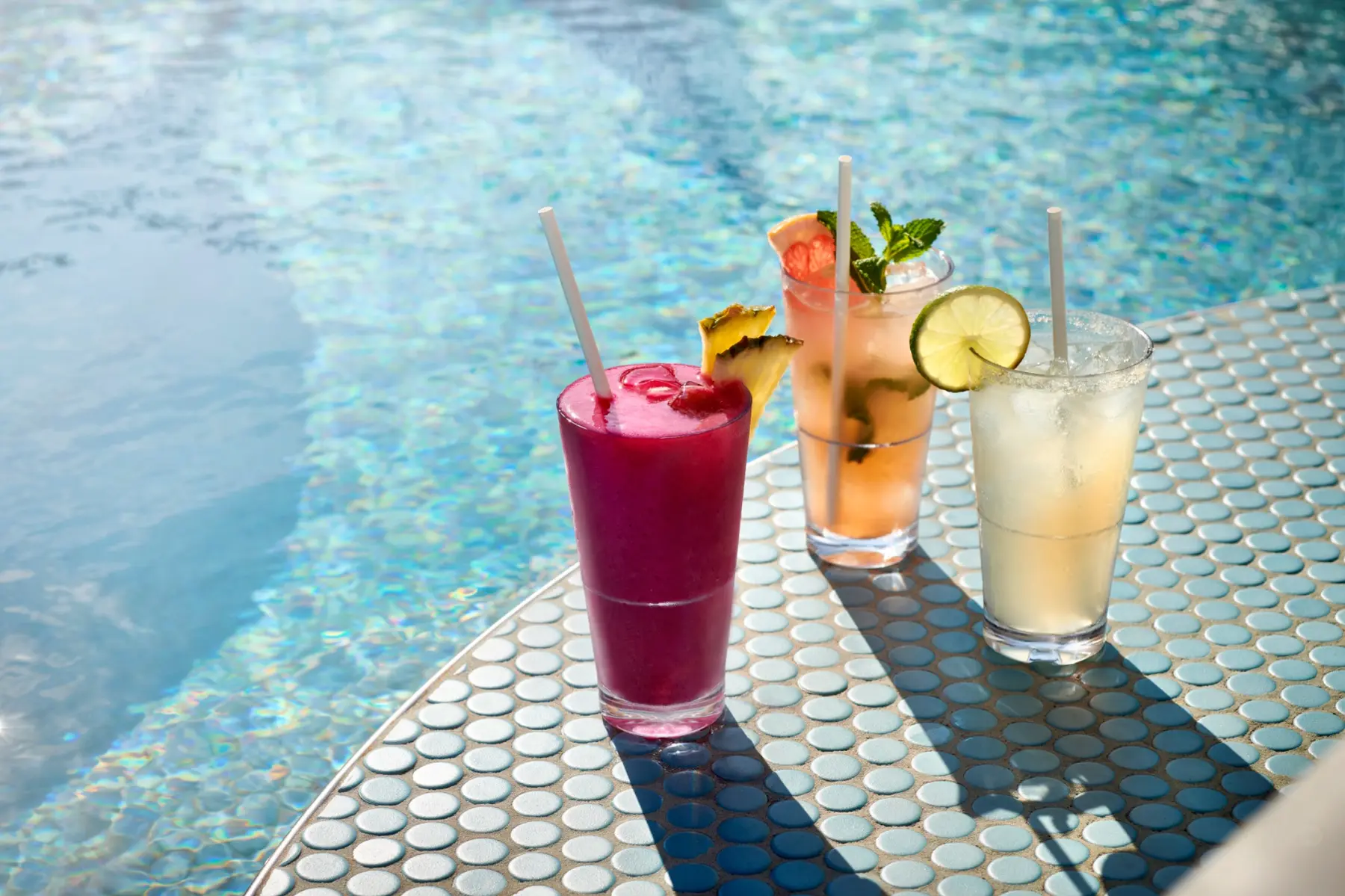 Cocktails and specialty drinks beside a Virgin Voyages pool