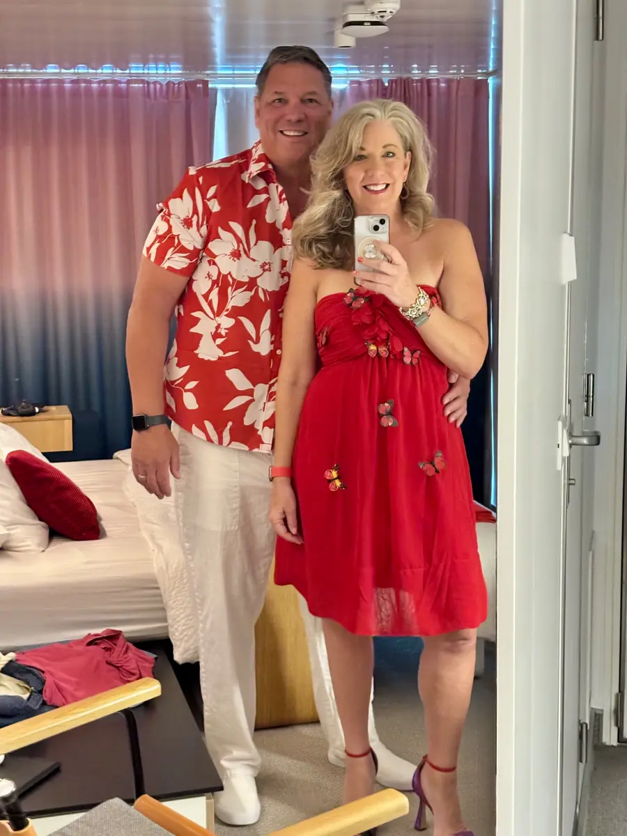 Couple dressed in red for Scarlet Night on Virgin Voyages